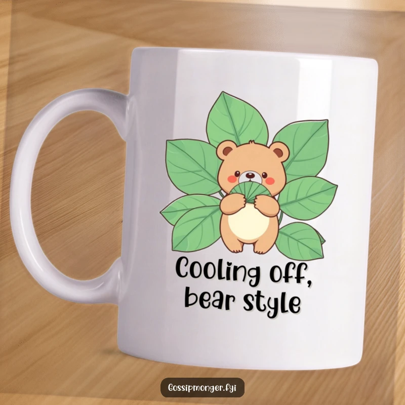 Funny Bear Mug: A small, round bear calmly holds a fan made of gigantic leaves, perfect for a cool and funny gift.