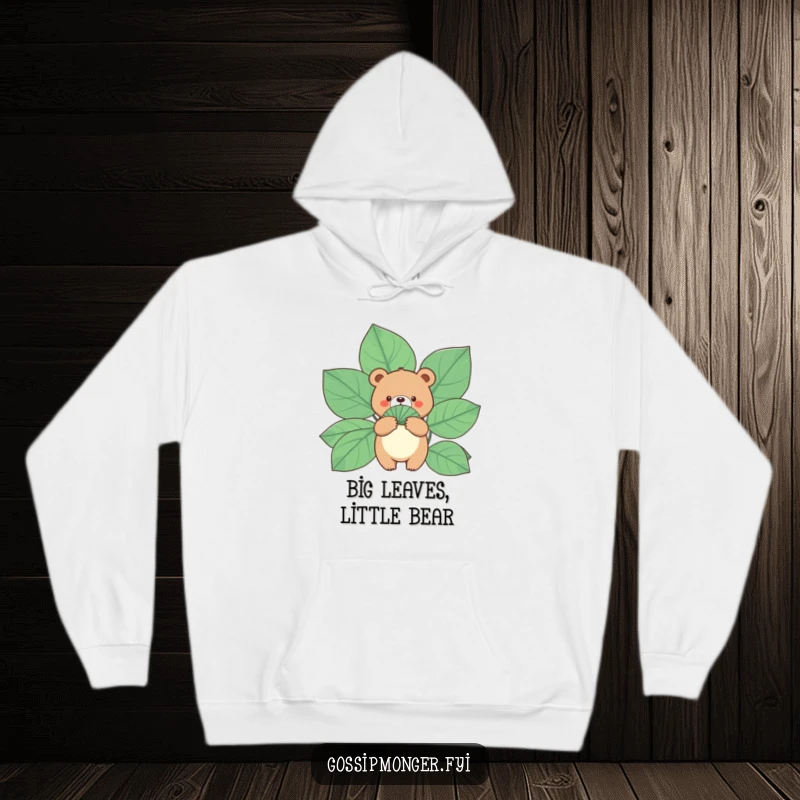 Funny Bear Hoodie: A small, round bear holds a fan made of gigantic leaves, offering cozy and humorous comfort.