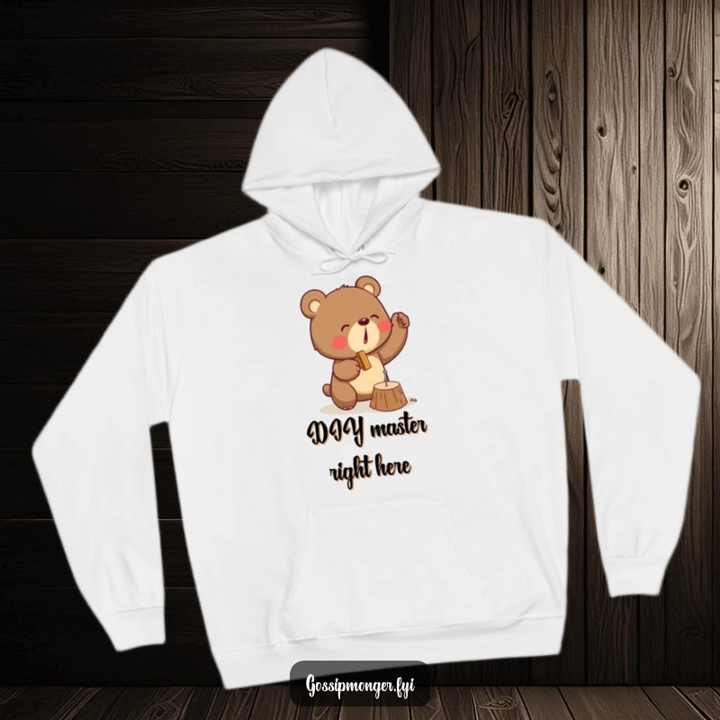Funny hoodie depicting a determined bear with a hammer, diligently trying to hit a tiny nail into wood with great effort.